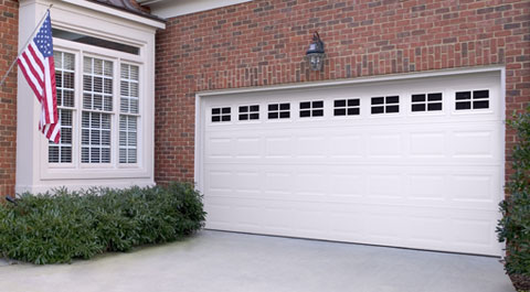 Garage Door in Fort Worth, TX with white paint on a brick house 